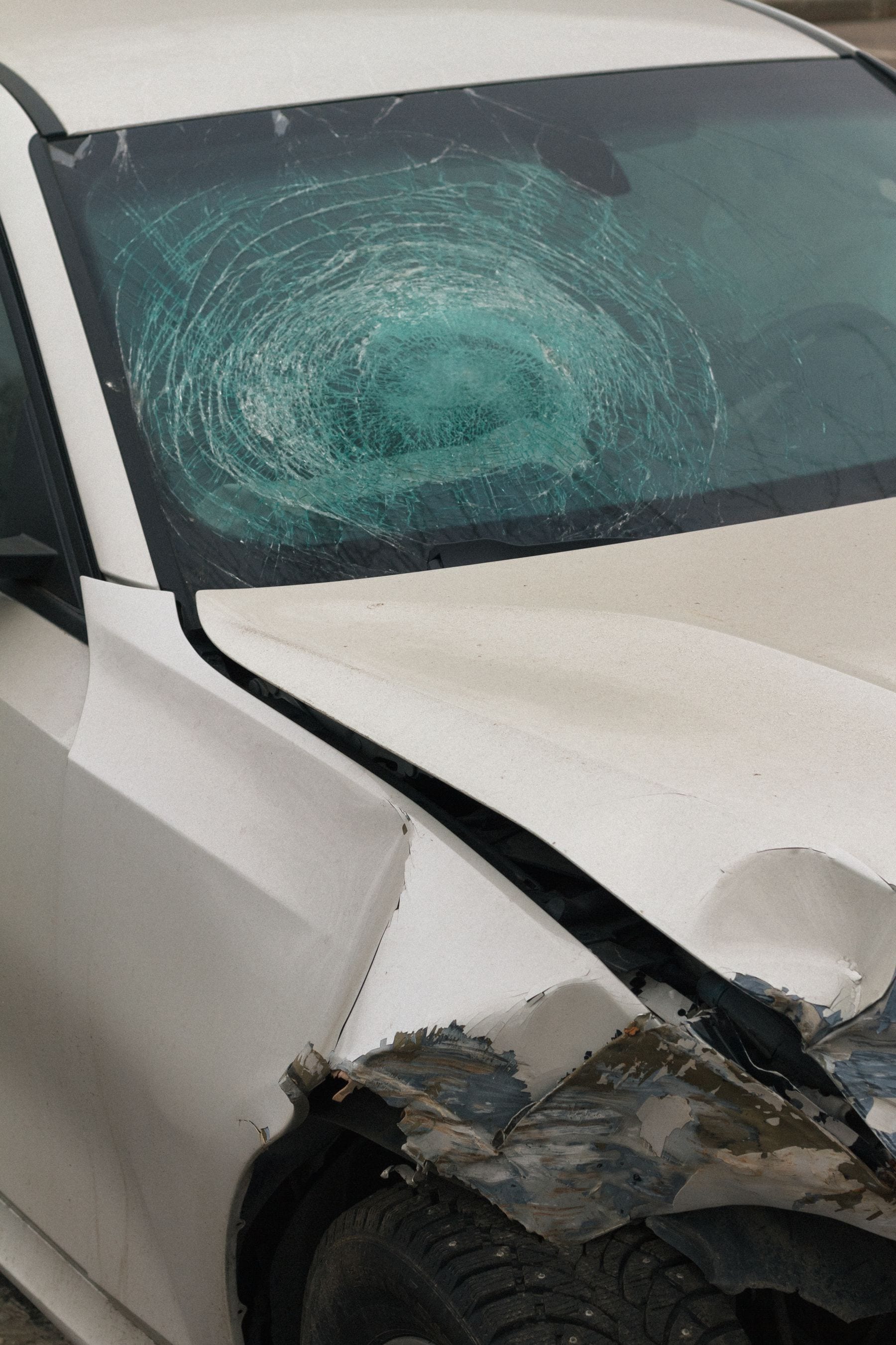 Damaged car with a broken windshield after a collision